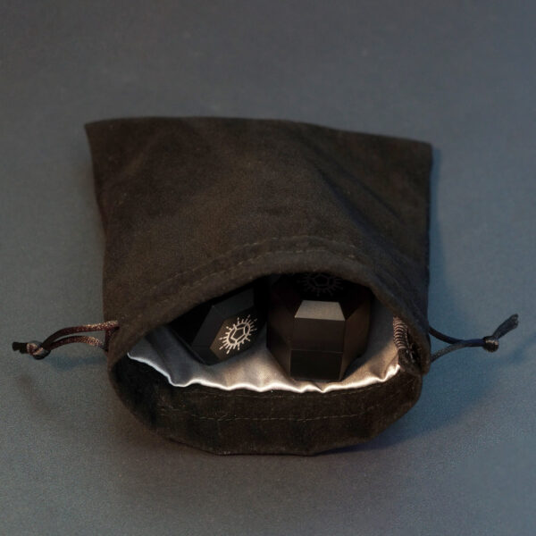 Square shaped black velvet drawstring bag with Single Chargers inside.